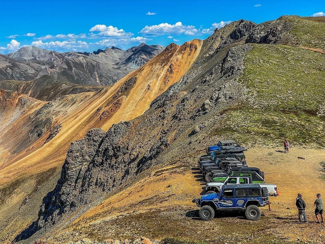 Jeeps lined up on top of mountain