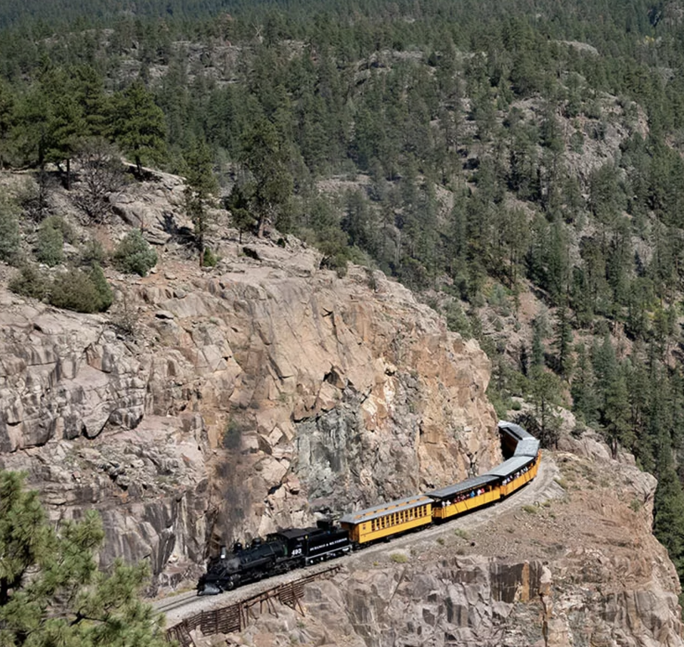 Train riding on the edge of a mountain cliff