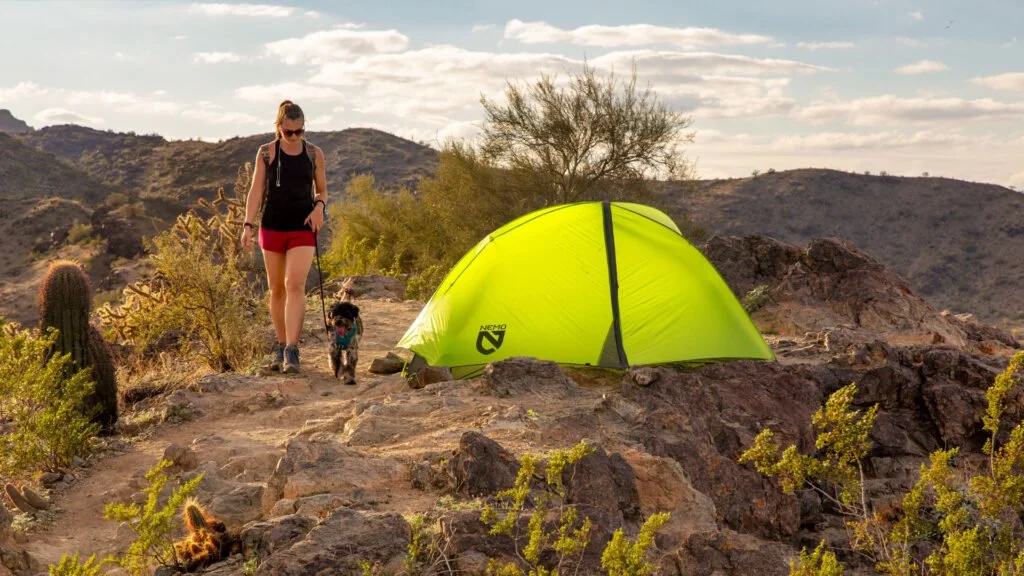 girk with dog hiking in desert in arizona
