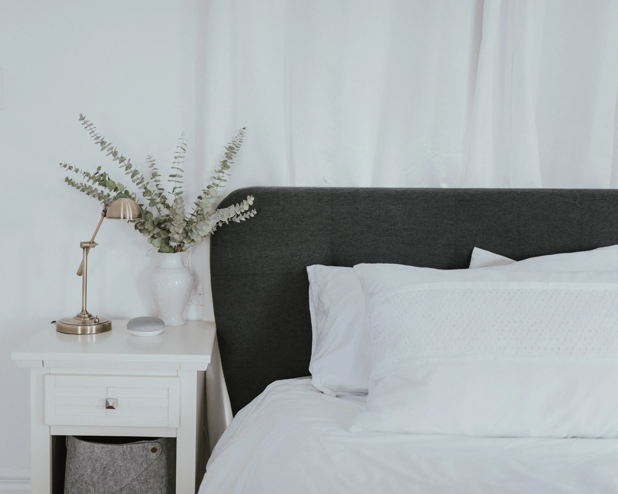 The Wild Decoelis | Master Bedroom Update | white nightstand from Bed bath and beyond with pharmacy light and vase