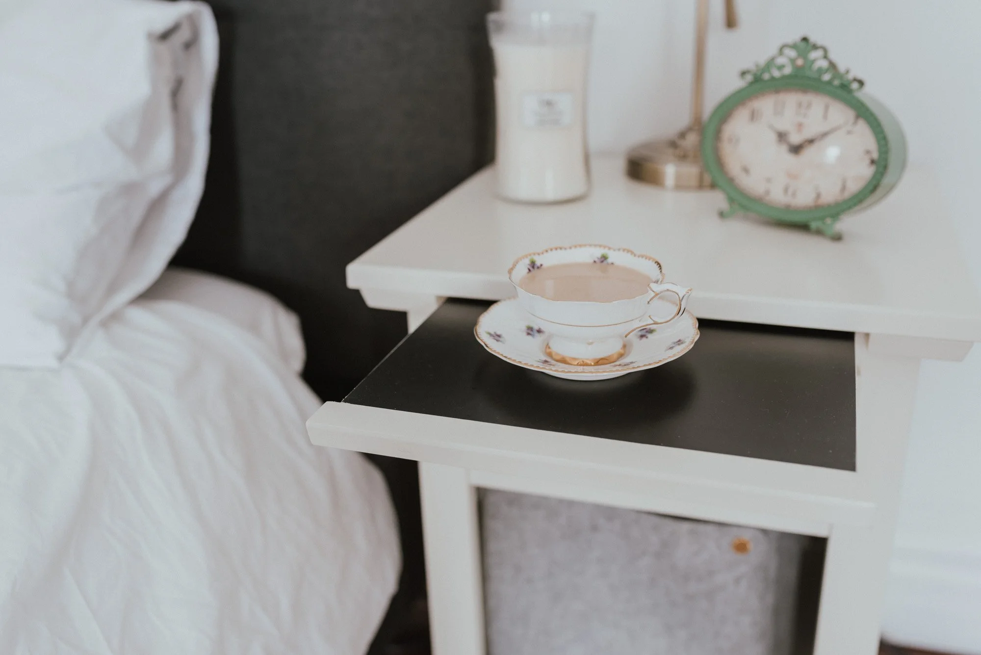 The Wild Decoelis | Master Bedroom Update | white nightstand from Bed bath and beyond with pharmacy light and vase with expandable tabletop