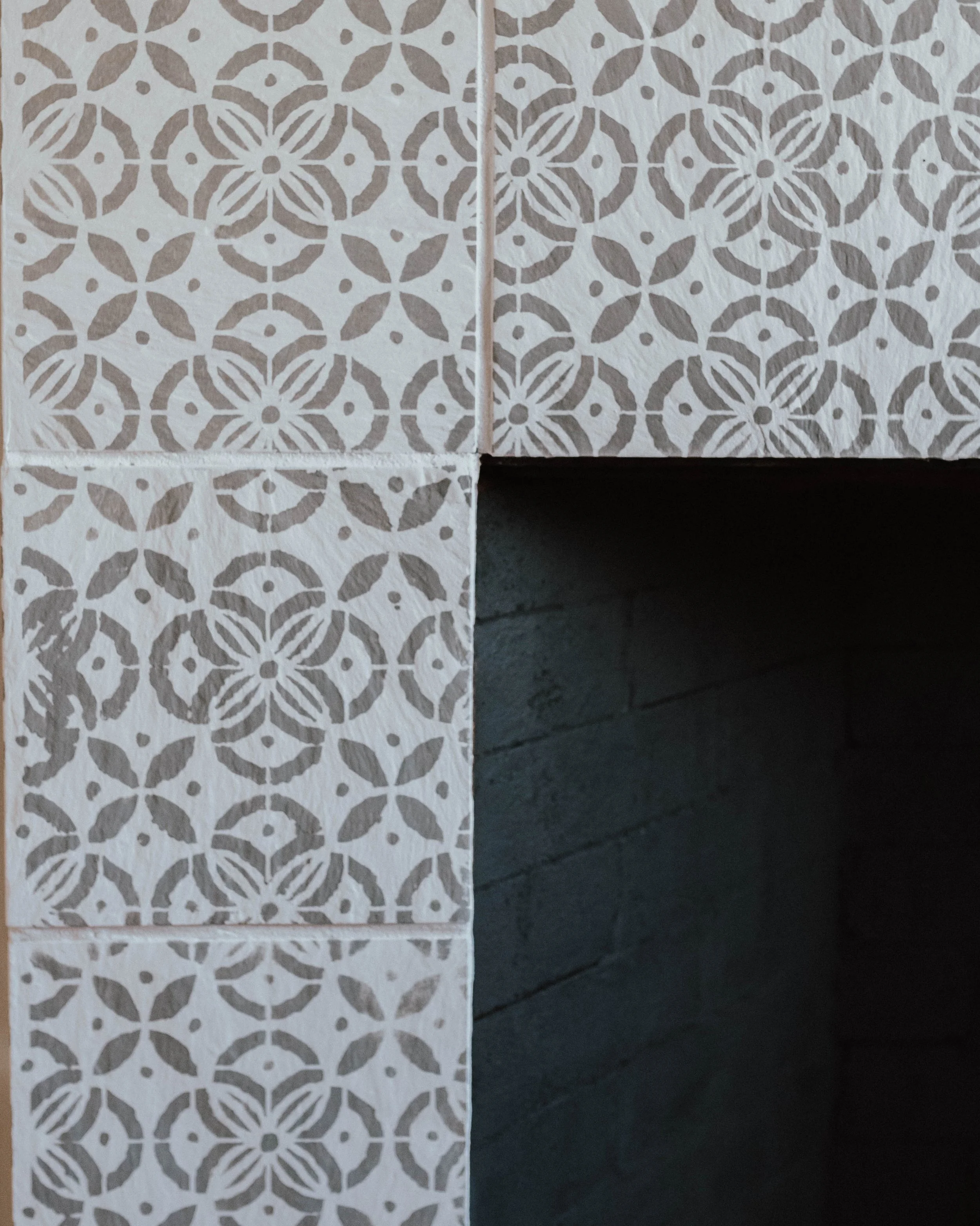 My $100 Fireplace Makeover with Behr Paint | The Wild Decoelis | stencilled tile fireplace DIY