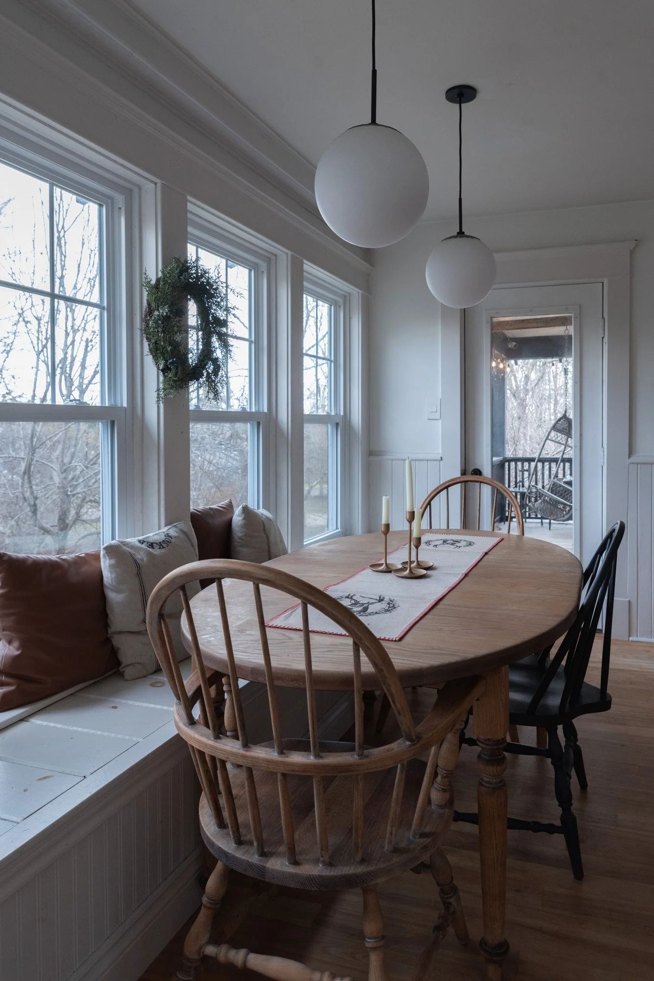 The Wild decoelis | 2020 Holiday Home Tour | Antique kitchen table with reindeer runner wreath and antique golden candlesticks
