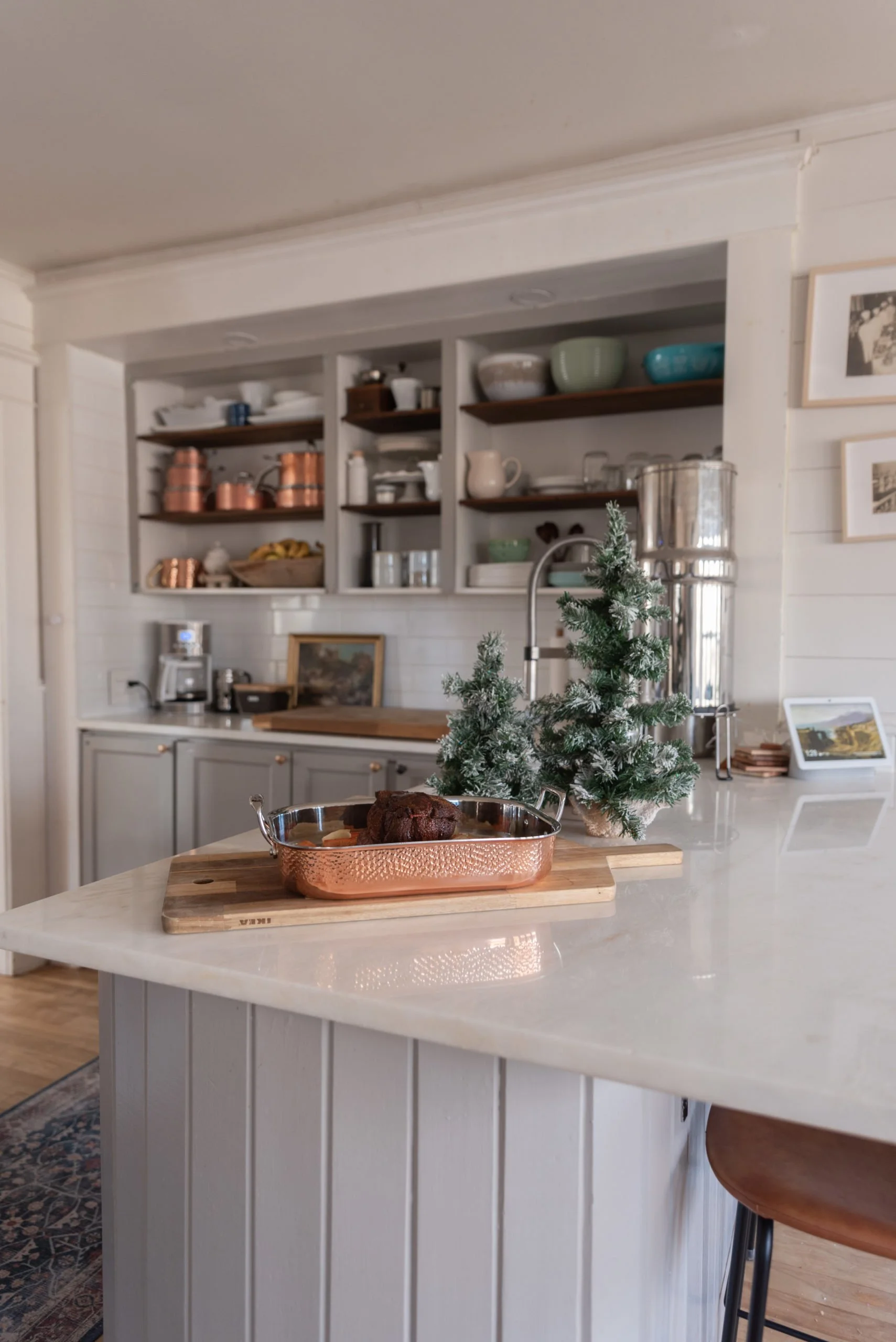 The Wild Decoelis | Holiday Home Tour | Gray kitchen with open shelving, Christmas decorations and white marble countertops