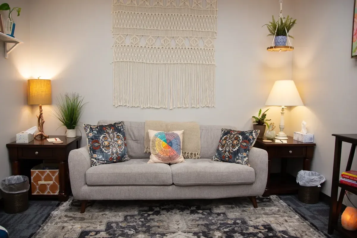 Therapy room with a sofa and side tables at Pivotal Counseling's Fort Collins office