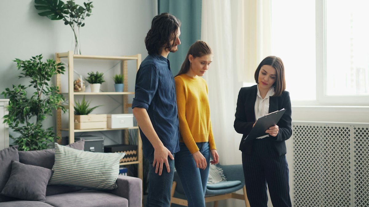 Leasing specialist touring an apartment with prospective renters