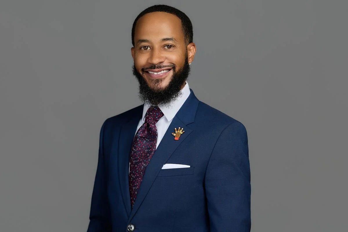 Professional headshot on a gray backdrop