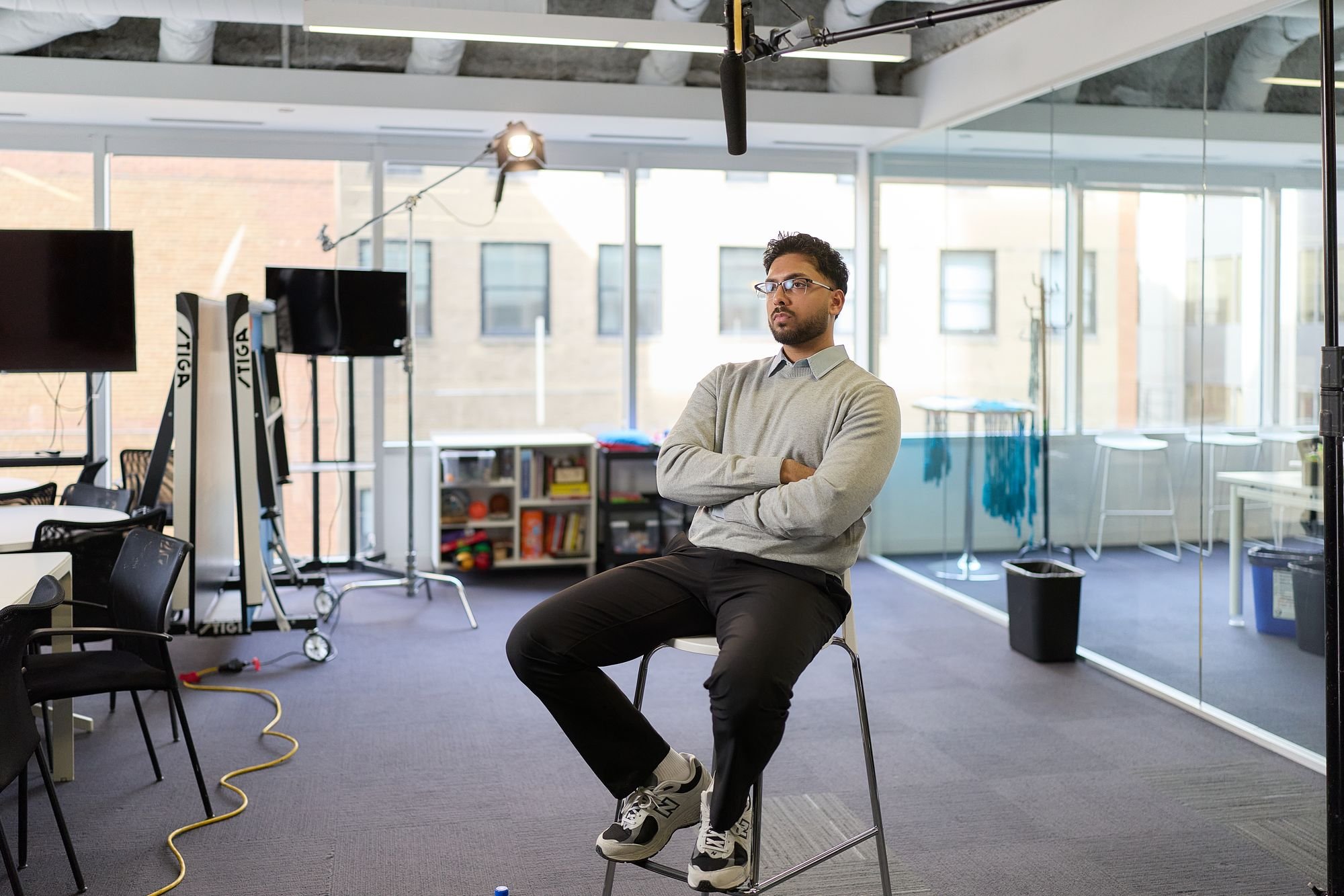 Interview subject seated under studio lights