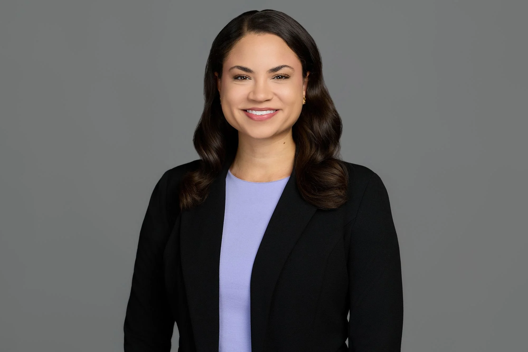 Professional headshot on a gray backdrop