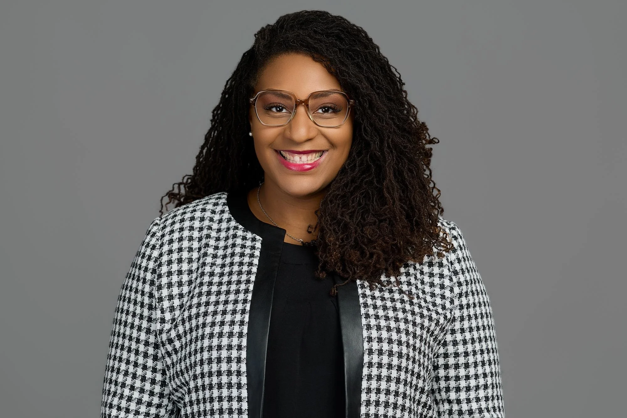 Professional headshot on a gray backdrop