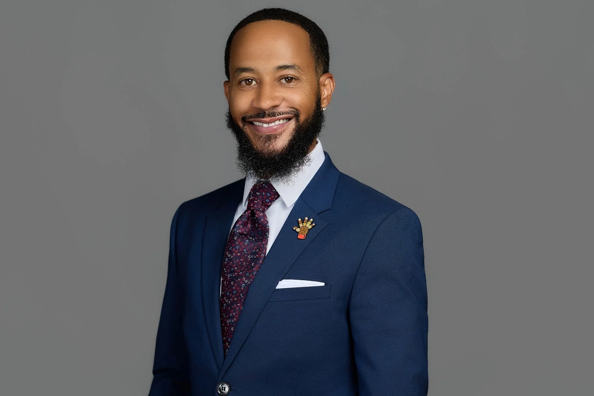 Professional headshot on a gray backdrop