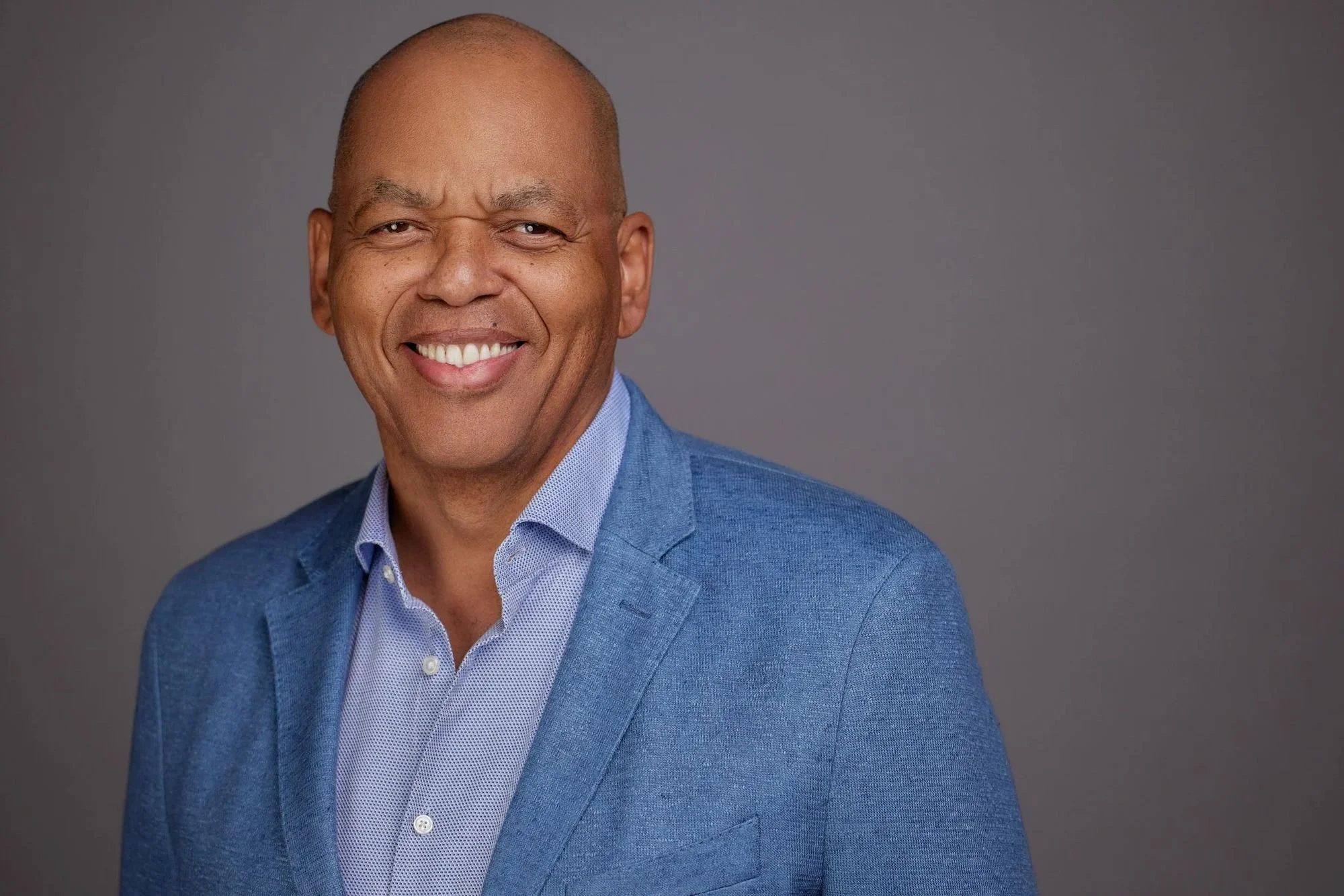 Professional headshot on a gray backdrop