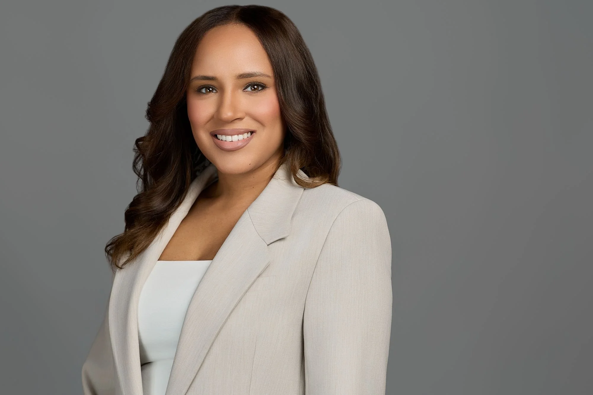 Professional headshot on a gray backdrop