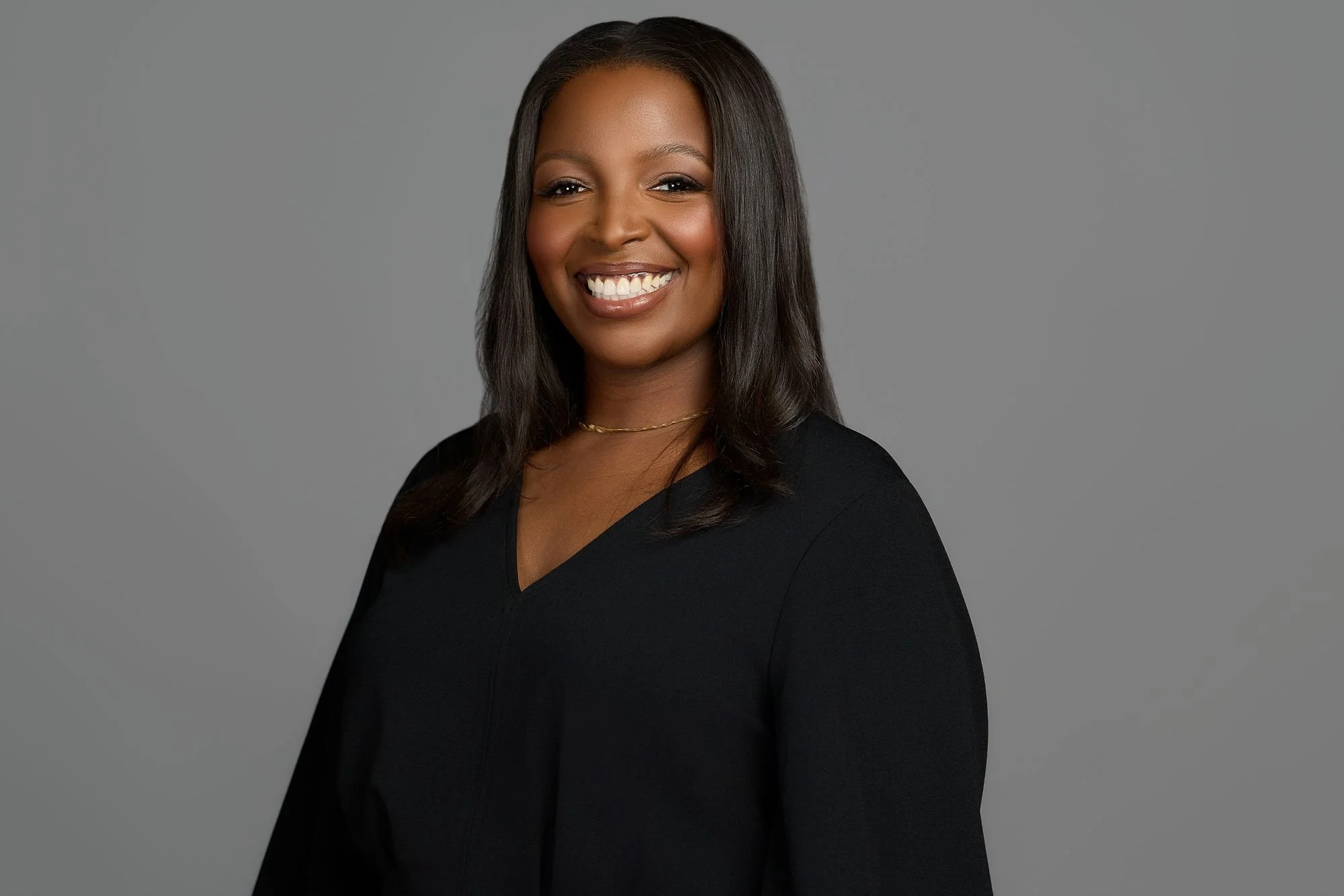Professional headshot on a gray backdrop
