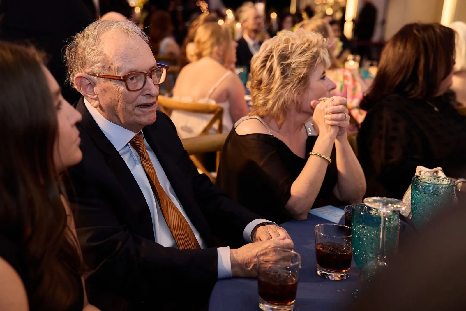 Guests talking and laughing over dinner