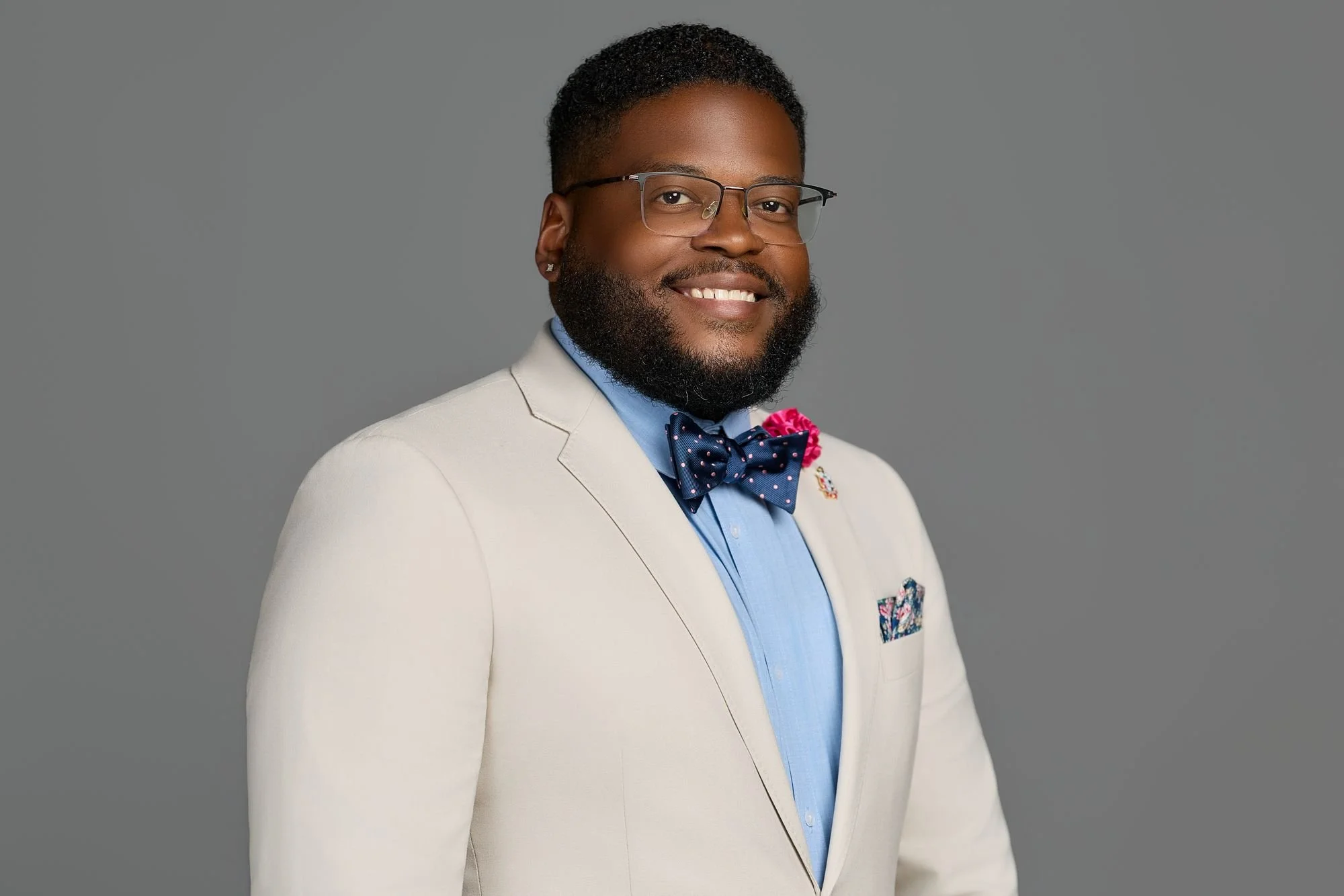 Professional headshot on a gray backdrop