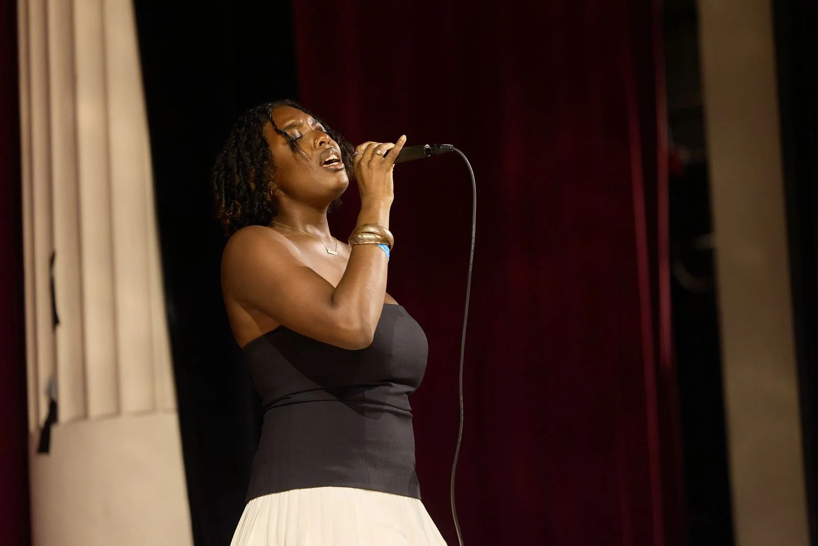 Singer performing with a microphone on stage