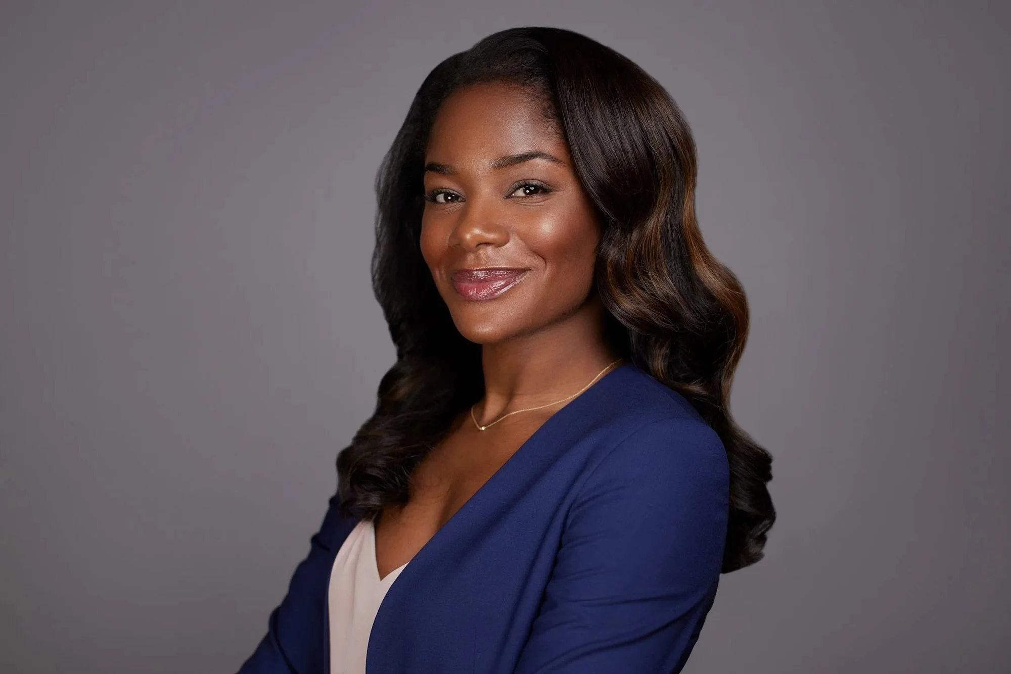 Professional headshot on a gray backdrop