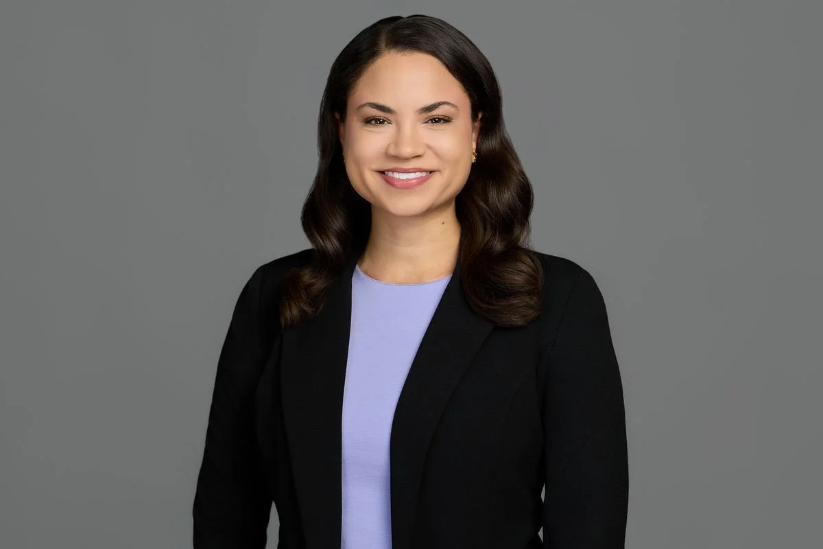 Professional headshot on a gray backdrop