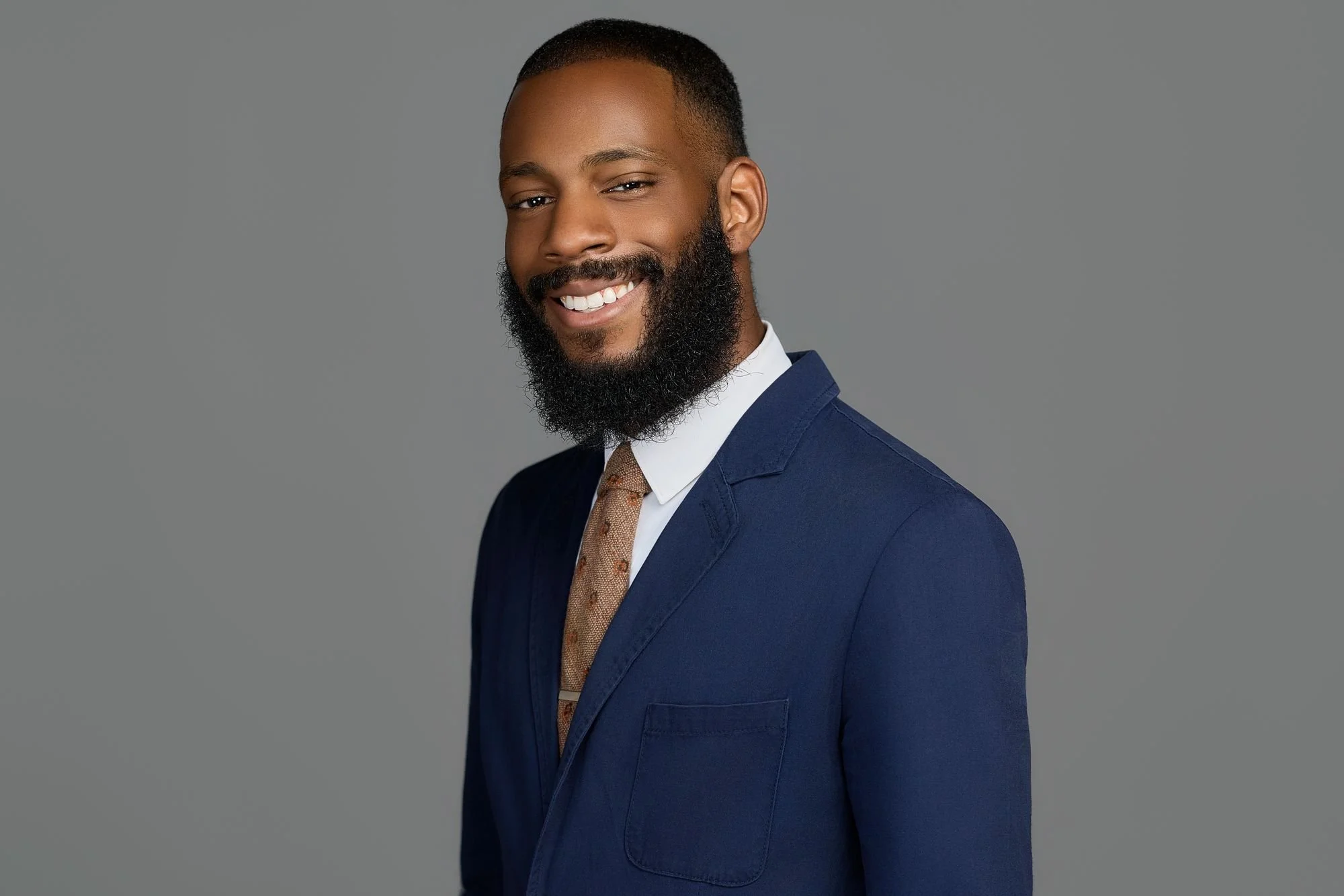 Professional headshot on a gray backdrop