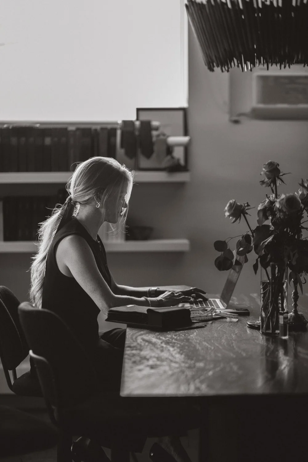 Lauren at her desk reviewing a client's online profile