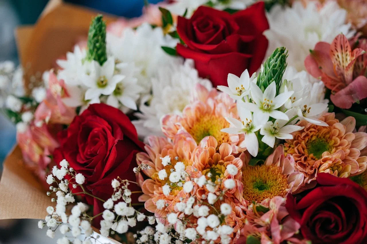 Funeral Floral Arrangement With Red Roses White Lilies And Soft Peach Chrysanthemums