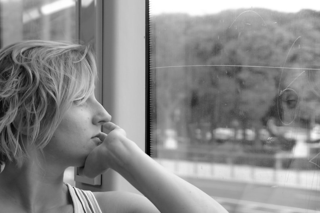 Woman contemplating at a window
