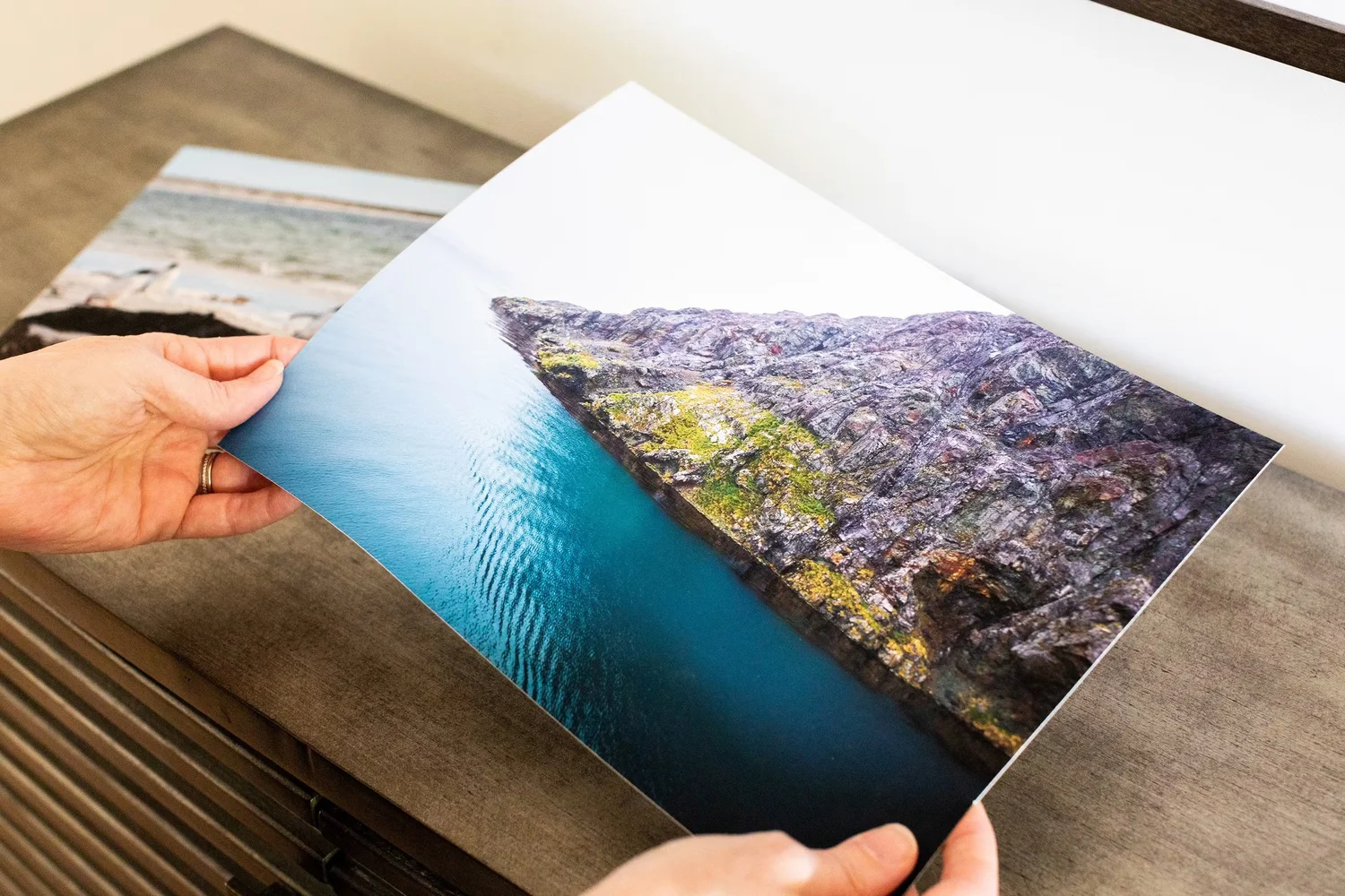 A landscape photograph printed on fine art paper and held for viewing