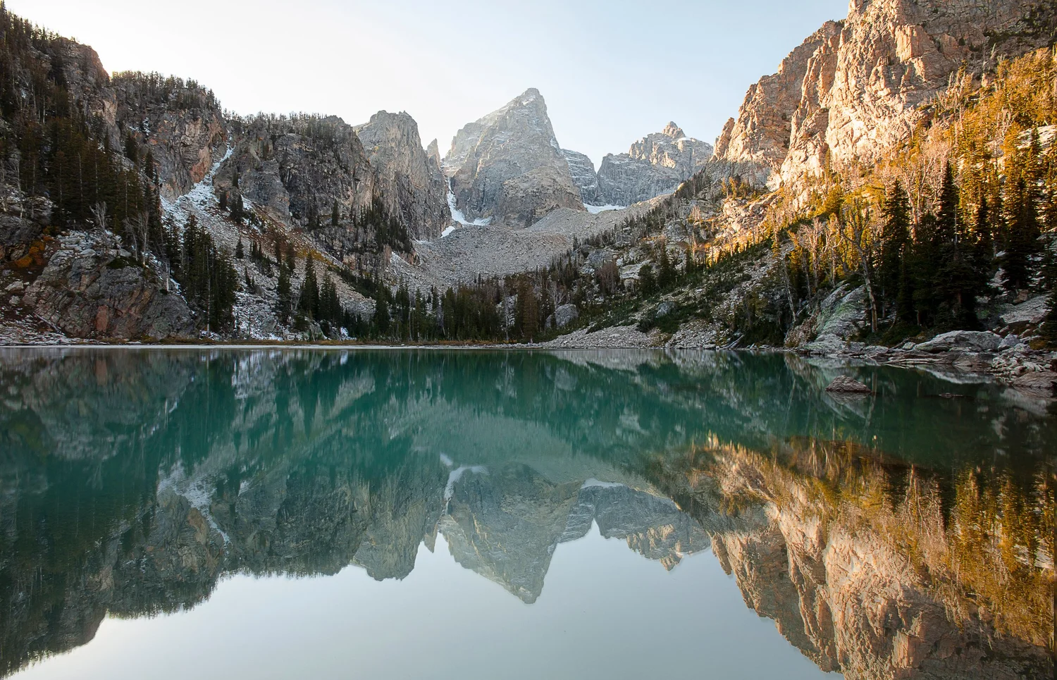 Delta Lake and the peaks of the Tetons reflected in turquoise water