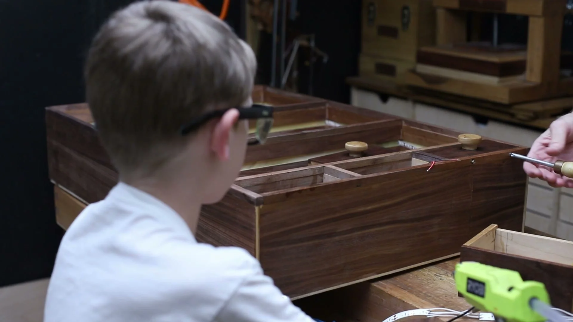 Applying finish to the walnut cabinet on the workbench.