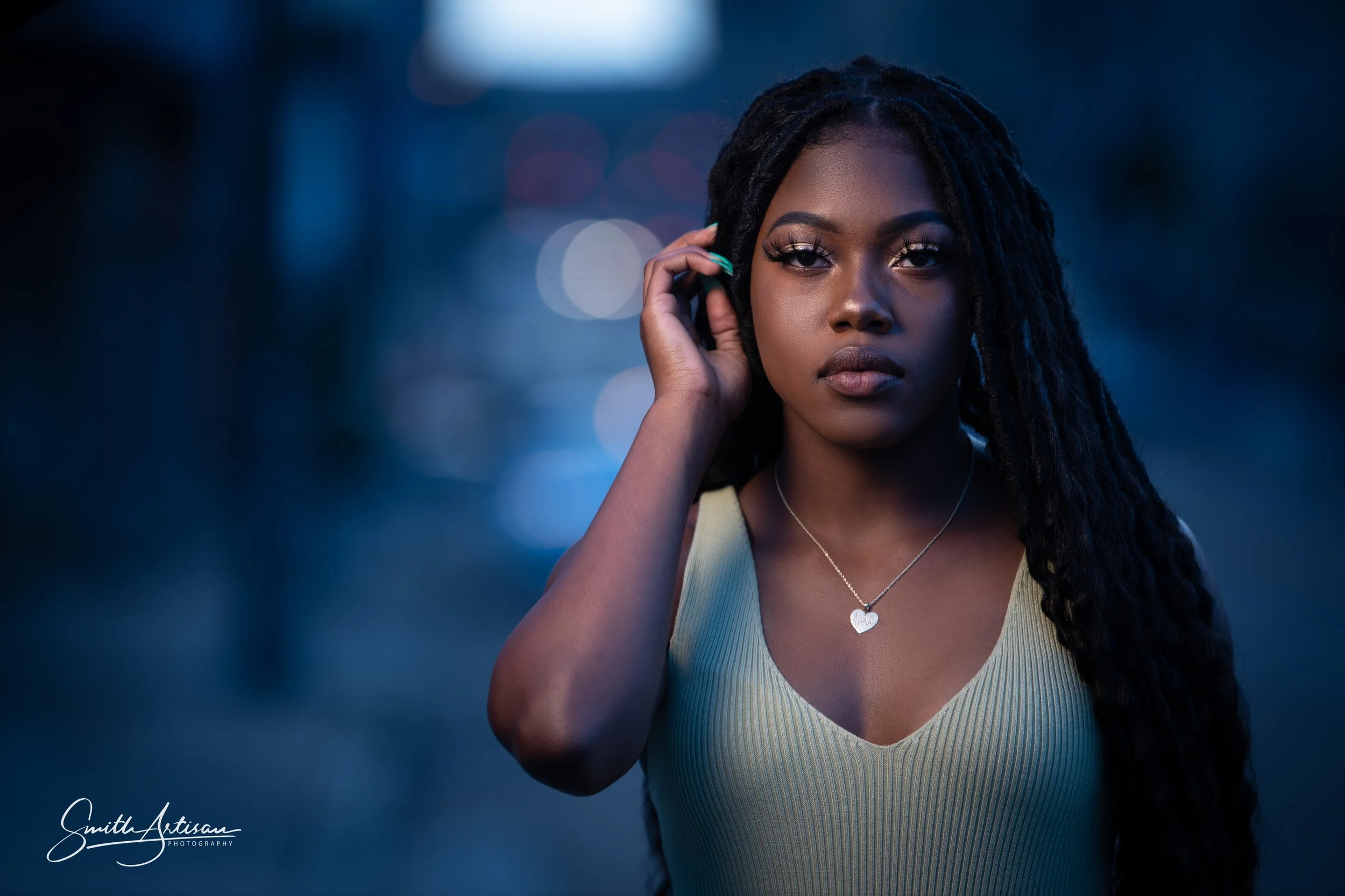 Stylish high school senior portrait in blue light