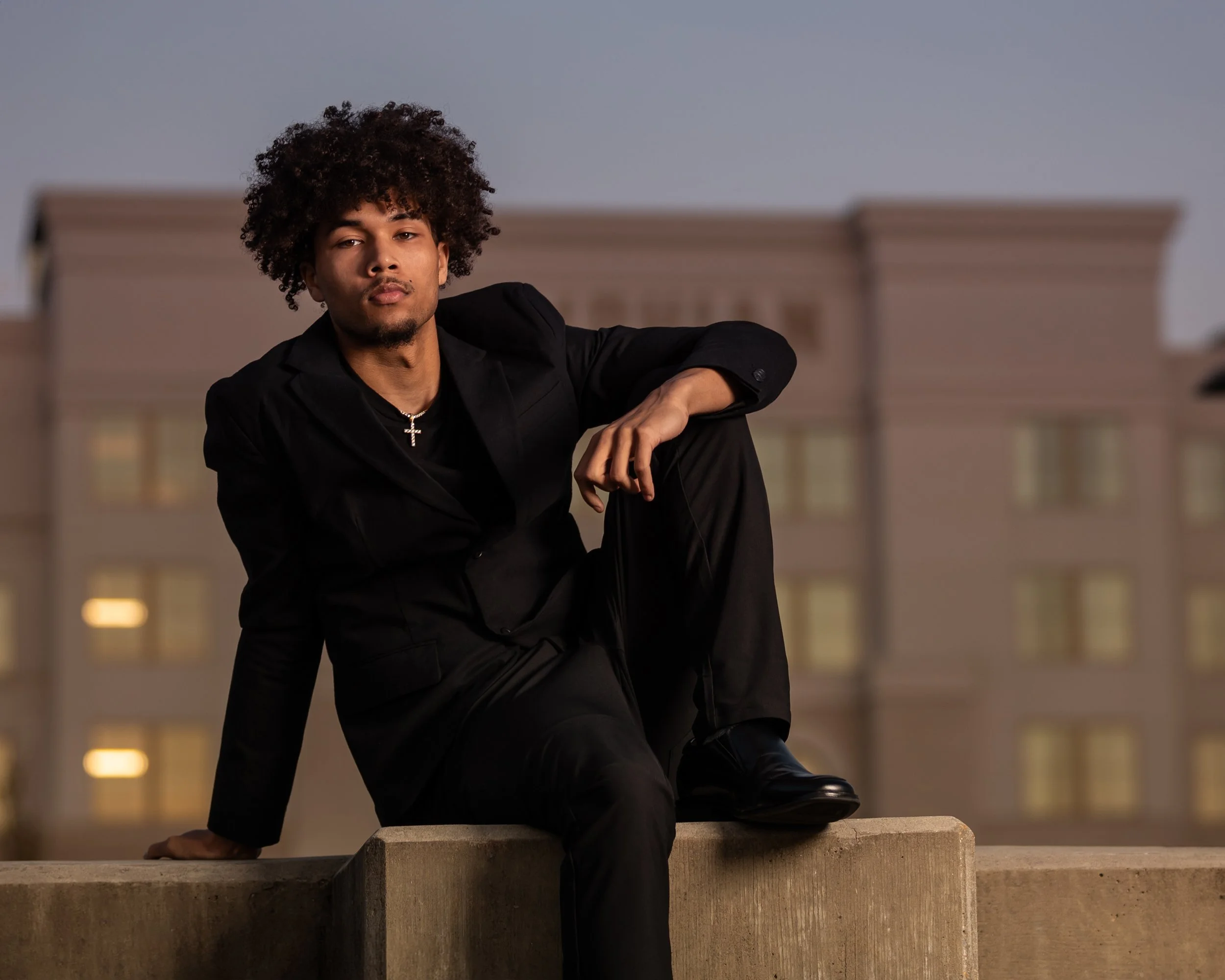 Modern senior portrait in a black suit