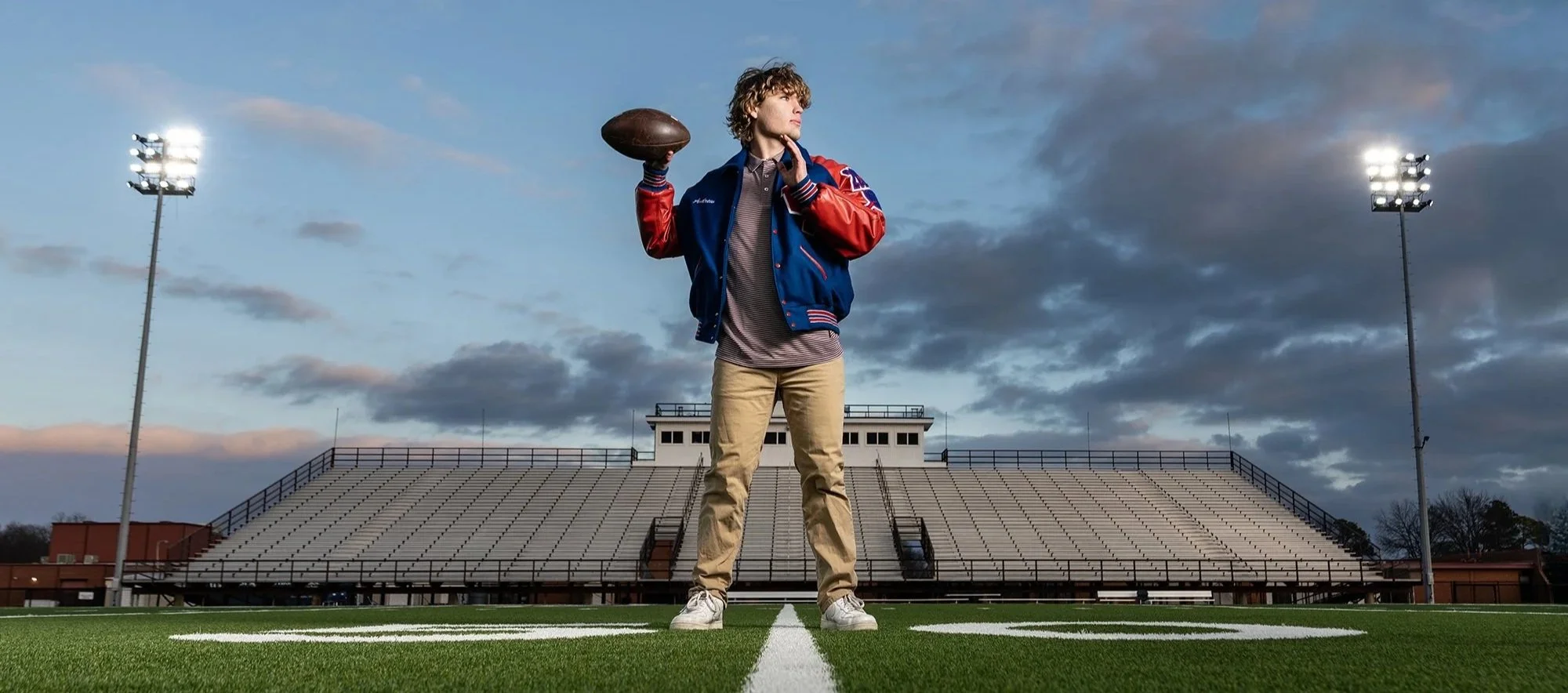 Senior football portrait under the stadium lights