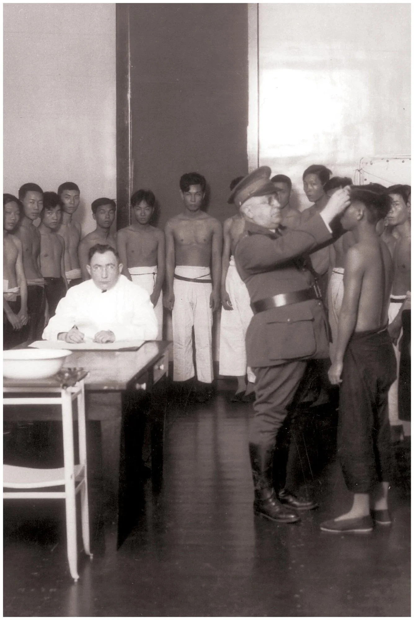 Men line up for a medical inspection