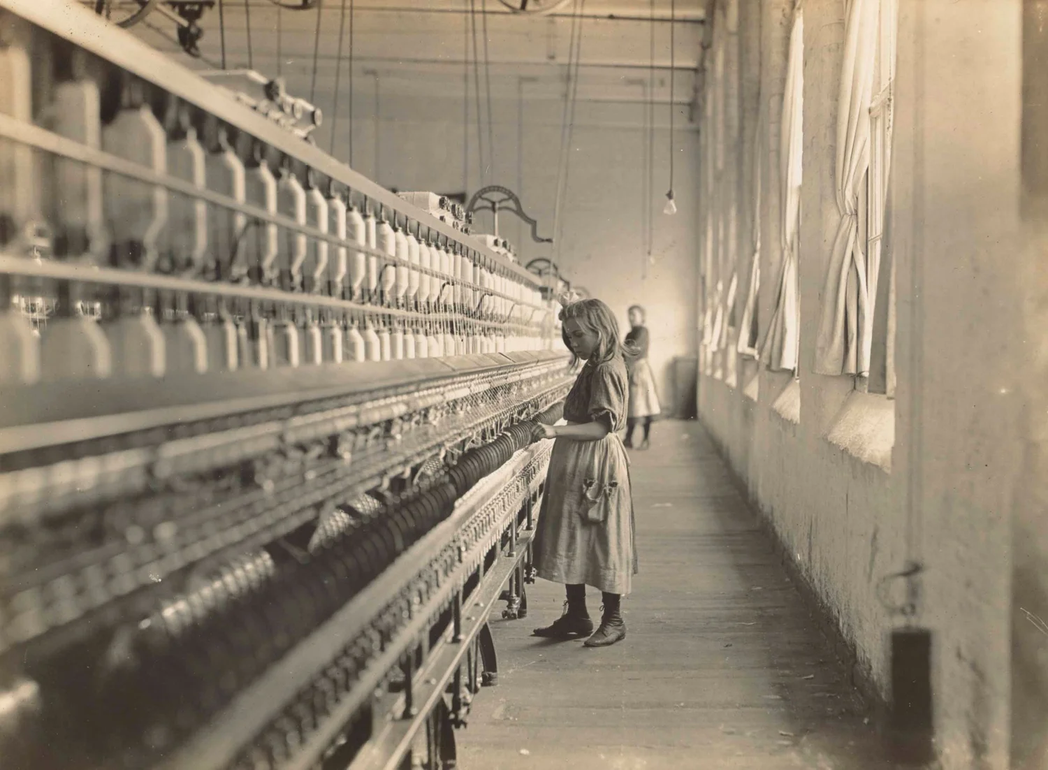 A young child at work in a cotton mill