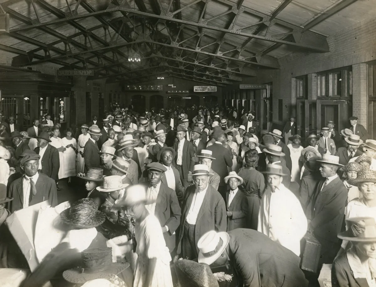 A crowded hall of arriving immigrants