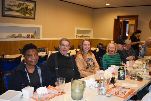 Happy people sitting at table in restaurant after meal