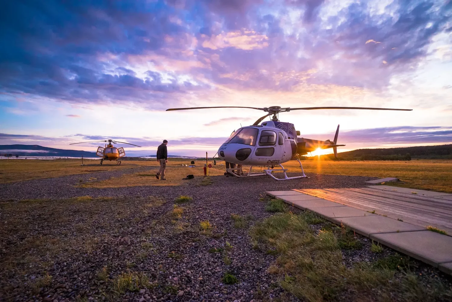 Still from Still Wild, a helicopter at sunset with crew unloading