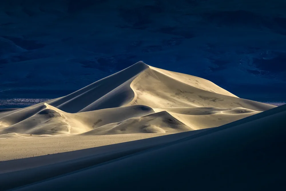 A lone dune under night sky, Death Valley