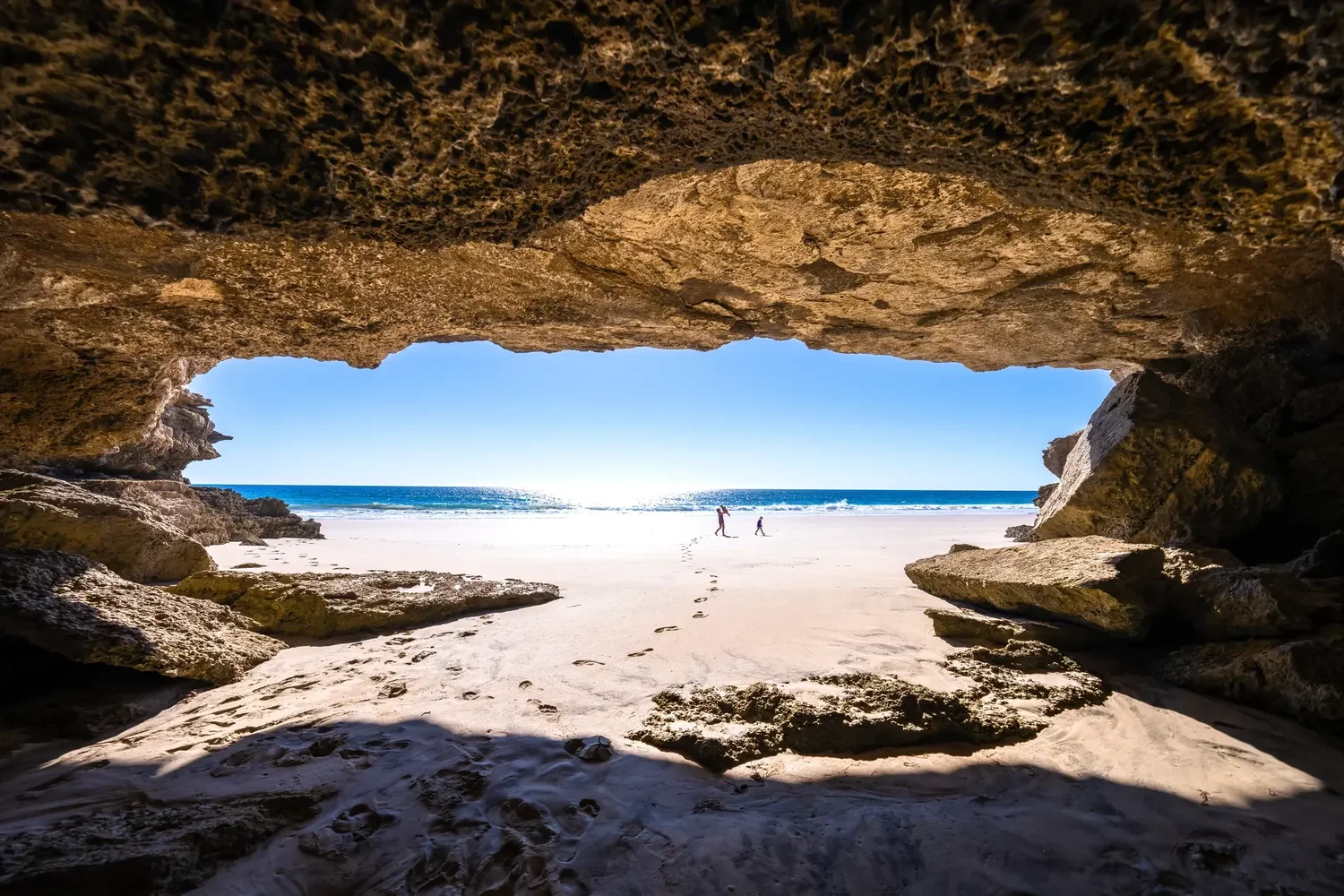 A sea cave opening onto a bright beach, Baja