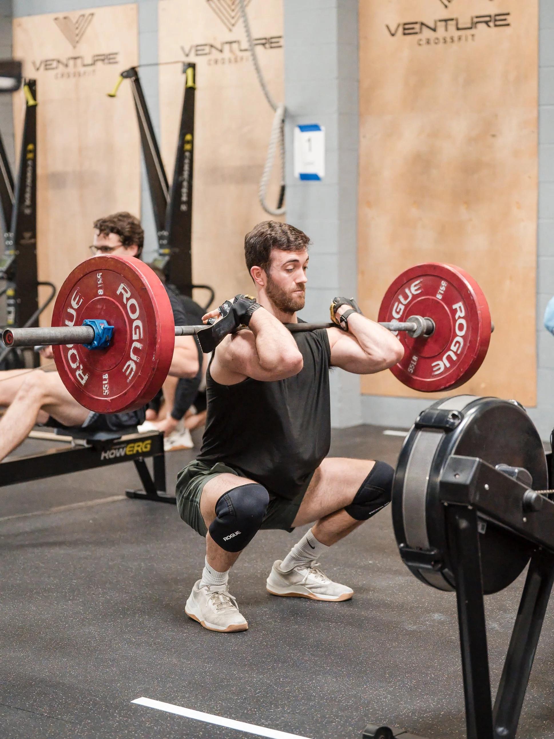 Athlete cleaning a loaded barbell