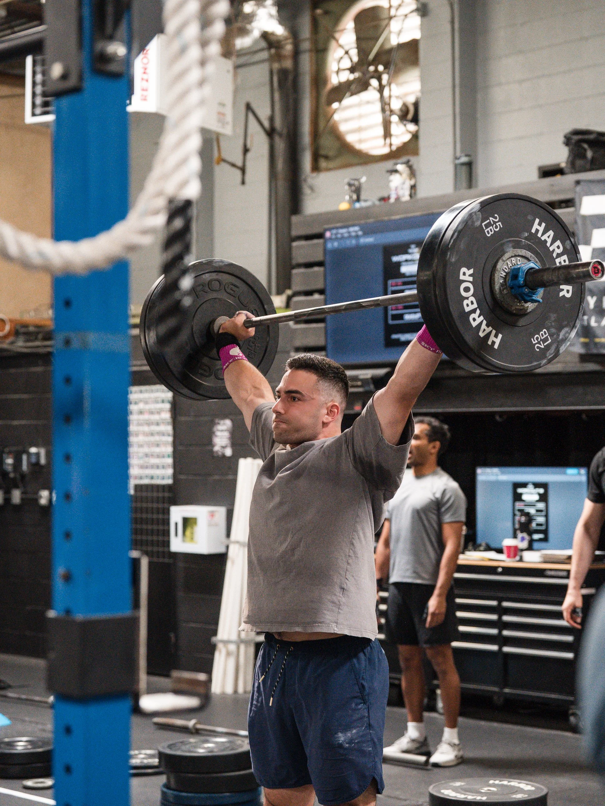 Coach giving a 1:1 cue mid-WOD