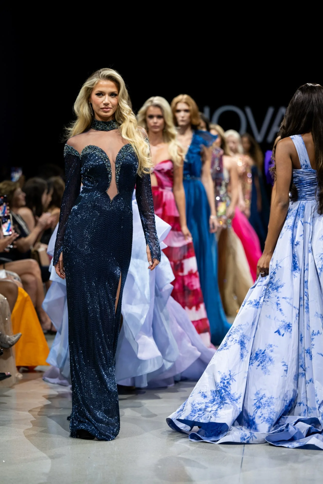 Model in a beaded navy JOVANI gown leading the Spring 2024 NYFW runway finale