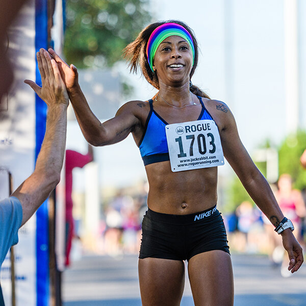 5K running woman with Rogue bib