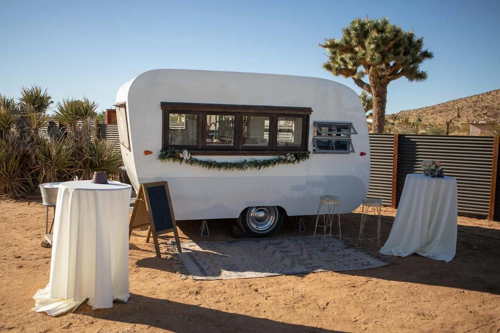 Vintage white trailer detail at Serenity Escape wedding venue in Yucca Valley with Joshua trees and desert landscape
