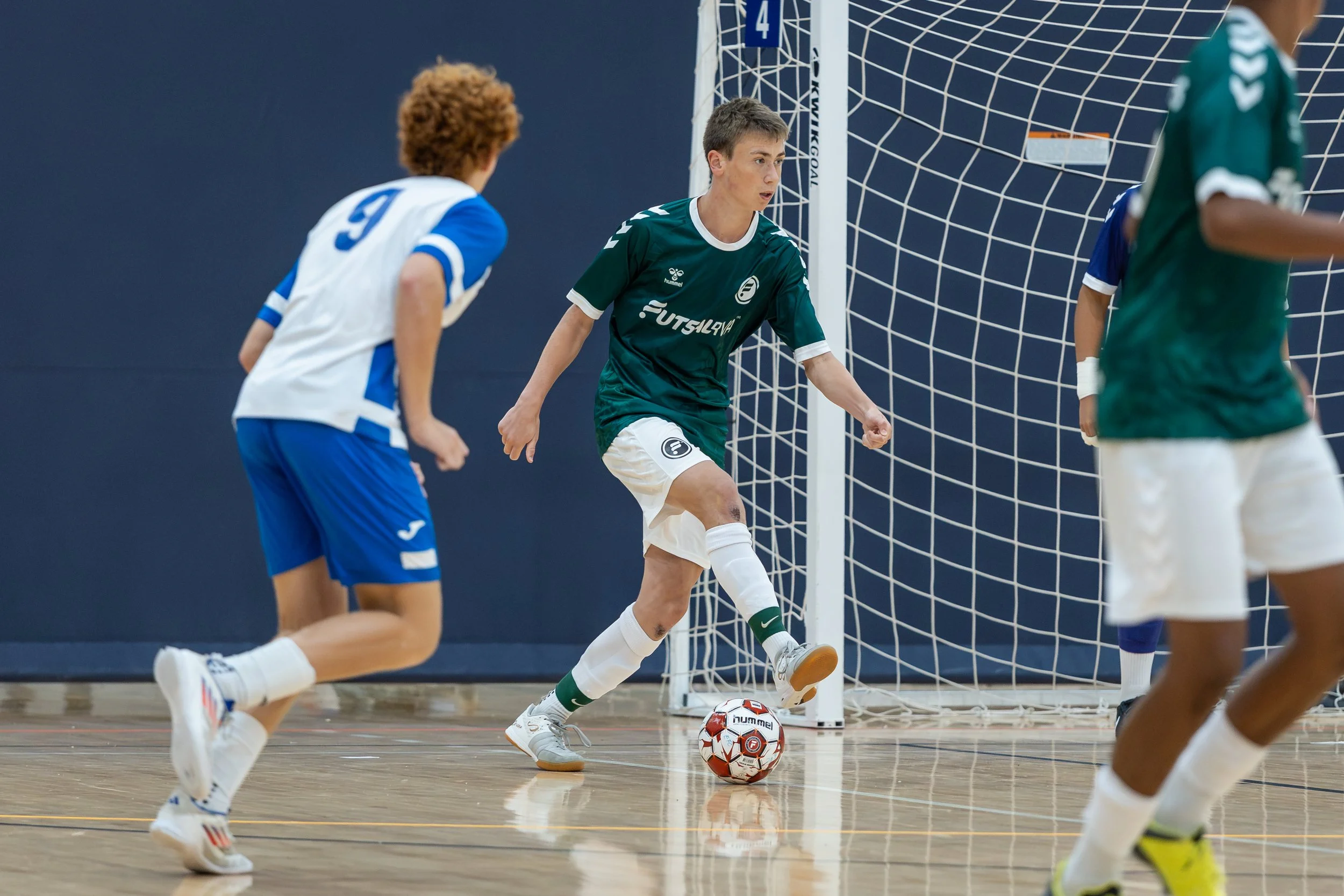 Boys futsal players competing during a tournament game