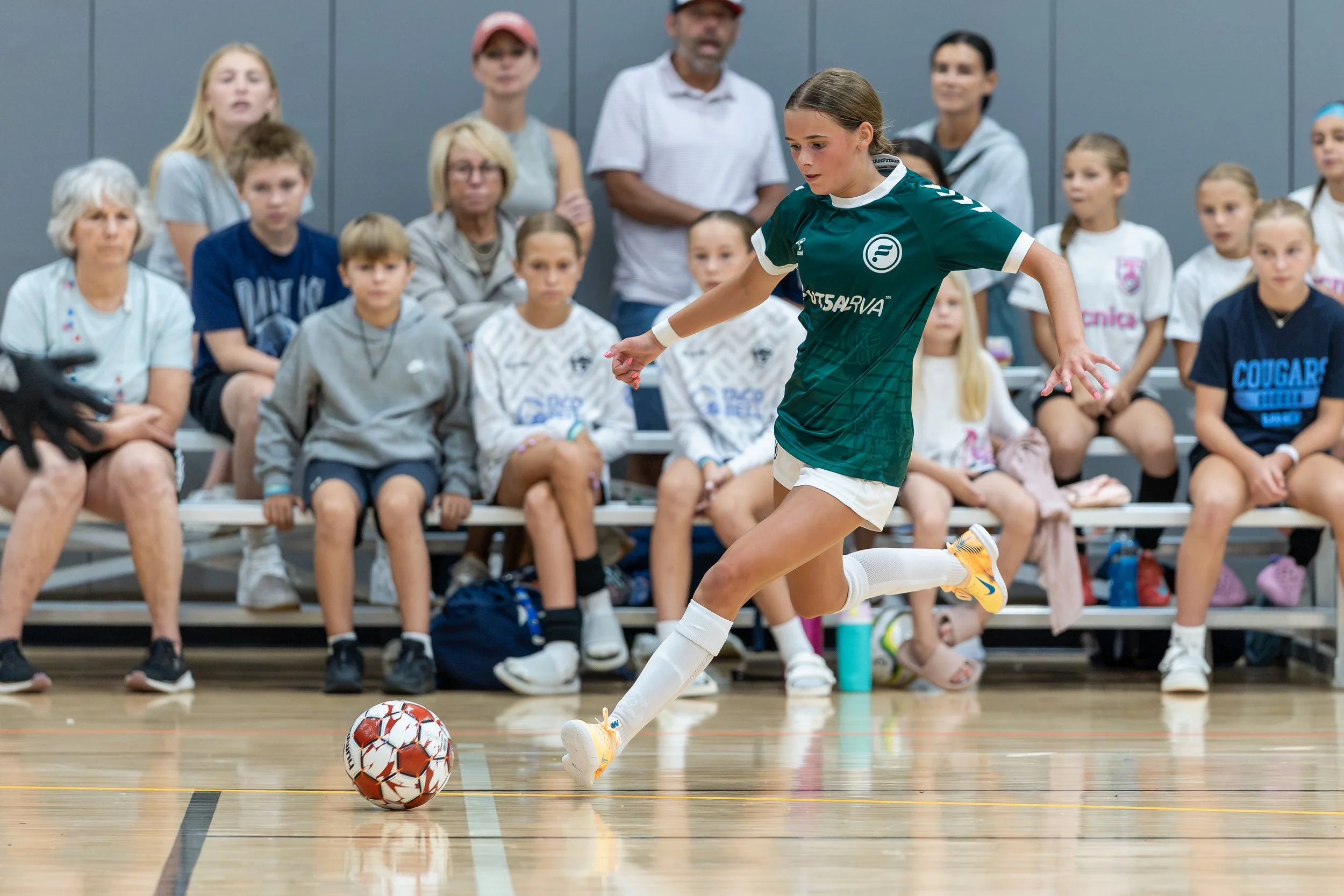Girls teams competing in a futsal tournament game