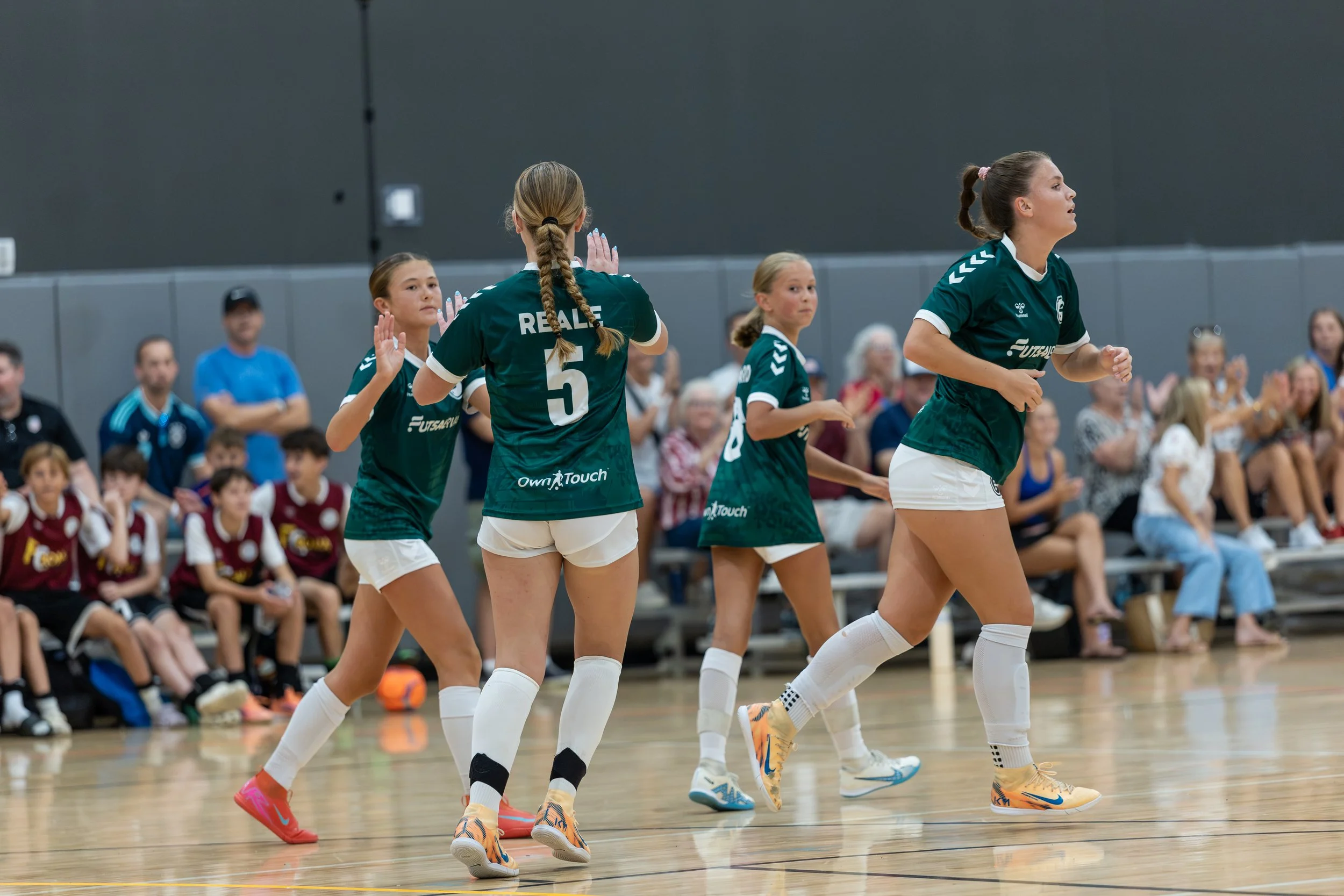 Girls futsal players competing during a tournament game