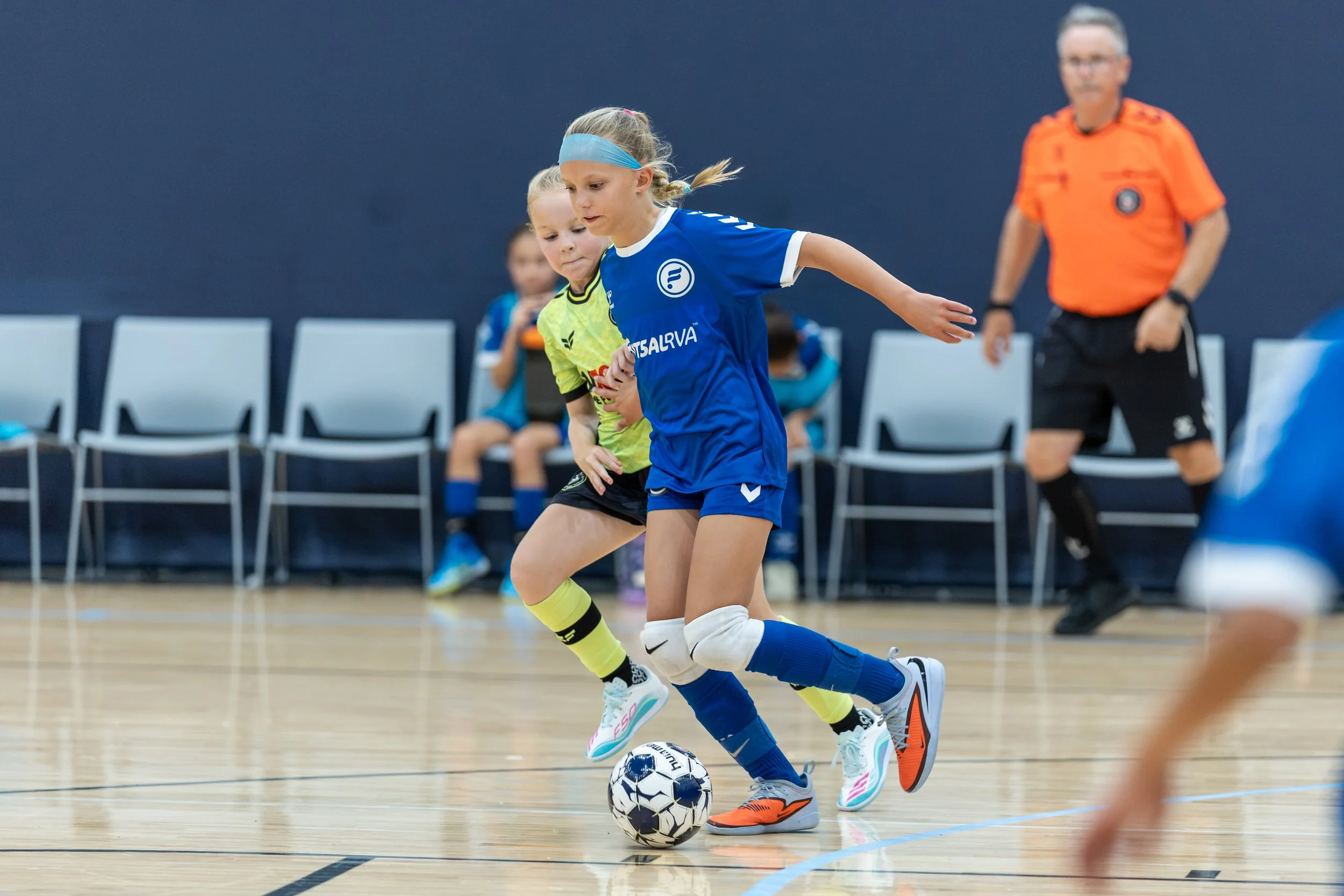 Girls futsal team competing in a game