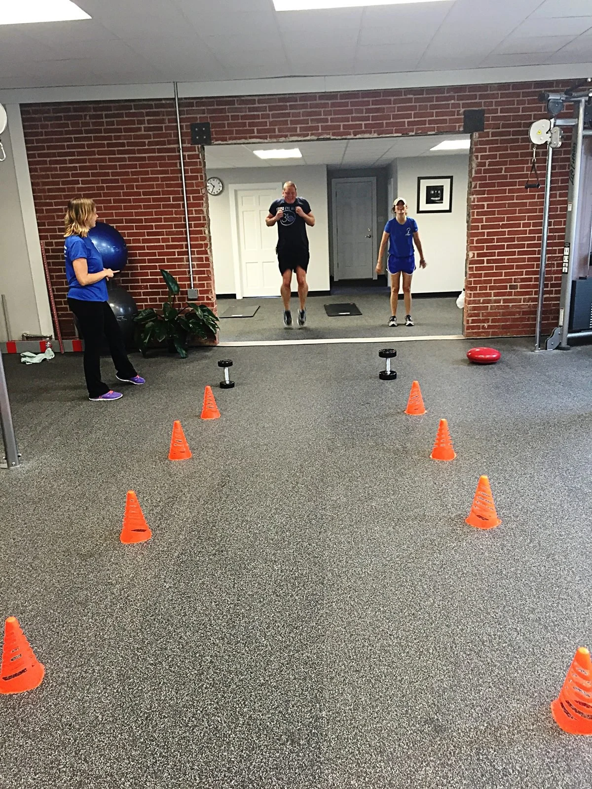 Coach watching a client's movement drill